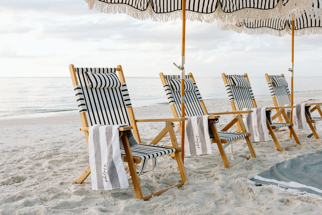 A group beach setup with striped umbrellas