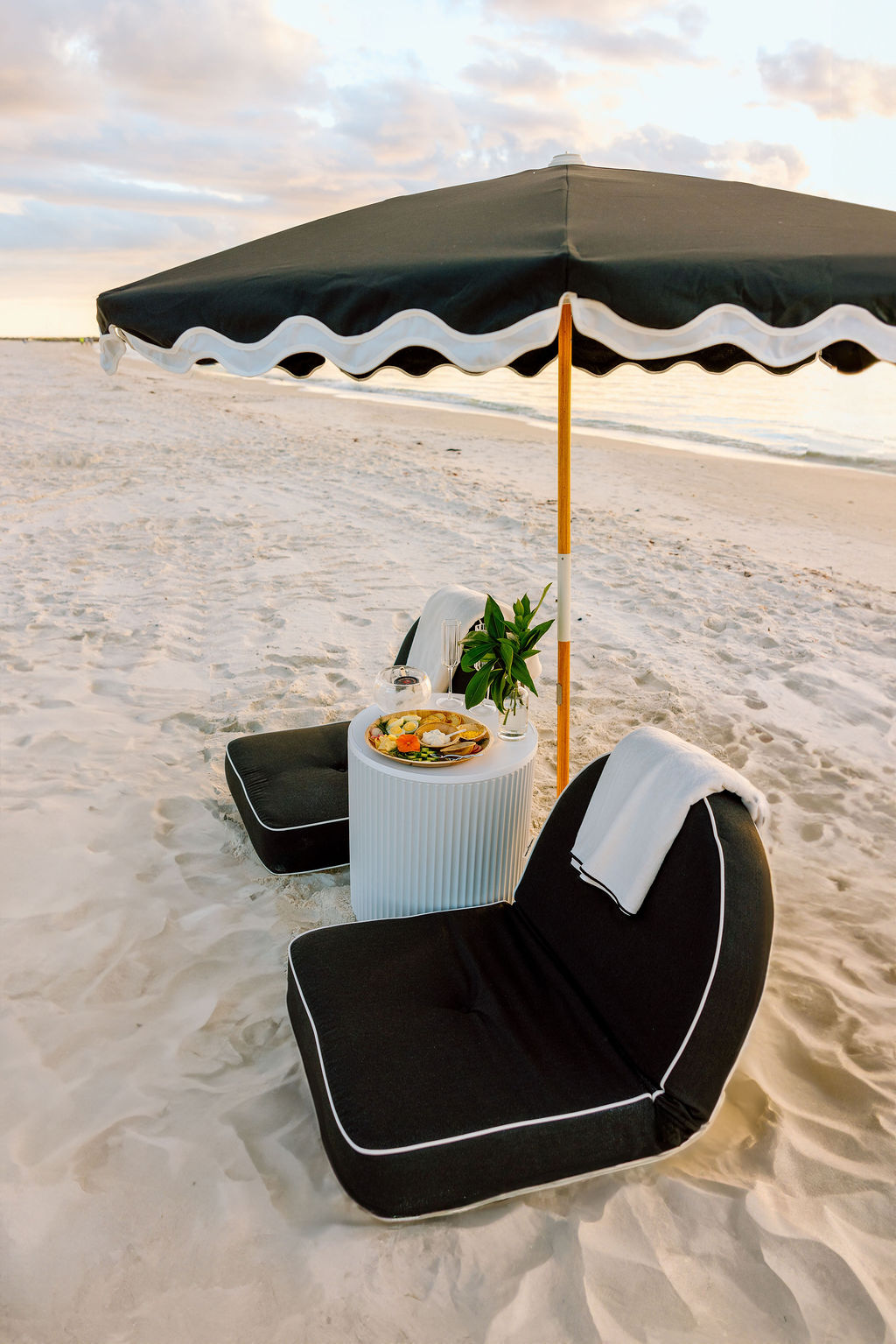 An intimate lounge setup for two on the sand