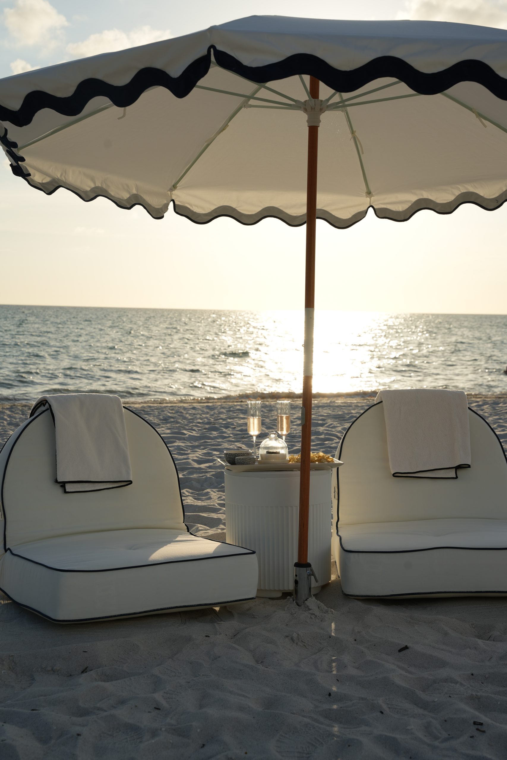 A beach setup waiting on the sand before guests arrive